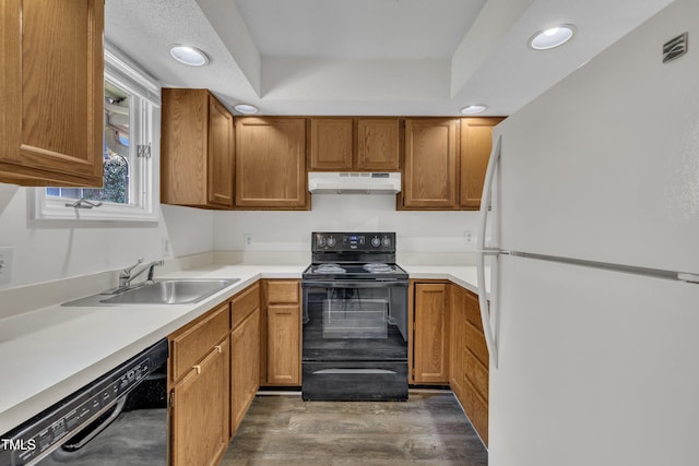 1442 Barton Place Dr, Raleigh, NC 27608 - kitchen featuring dark wood-style flooring, recessed lighting, black appliances, under cabinet range hood, and a sink