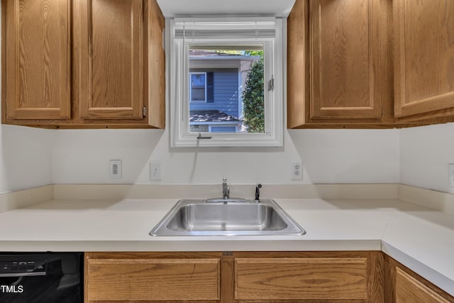 1442 Barton Place Dr, Raleigh, NC 27608 - kitchen with brown cabinets, light countertops, a sink, and black dishwasher