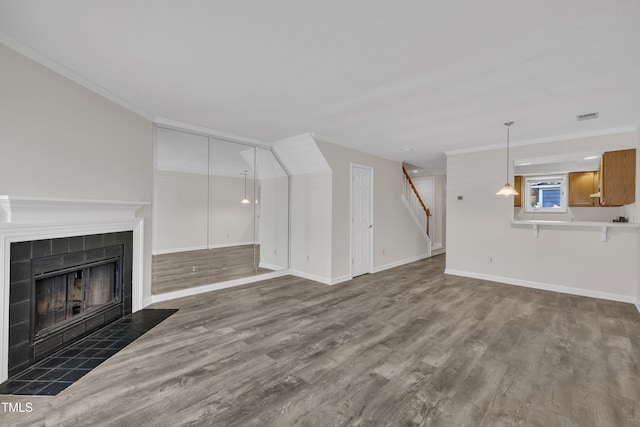 1442 Barton Place Dr, Raleigh, NC 27608 - unfurnished living room with wood finished floors, a fireplace, ornamental molding, and baseboards