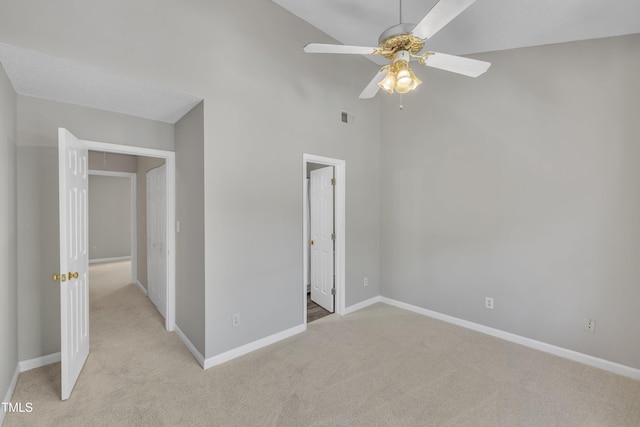 1442 Barton Place Dr, Raleigh, NC 27608 - unfurnished bedroom featuring visible vents, baseboards, a high ceiling, ceiling fan, and light carpet