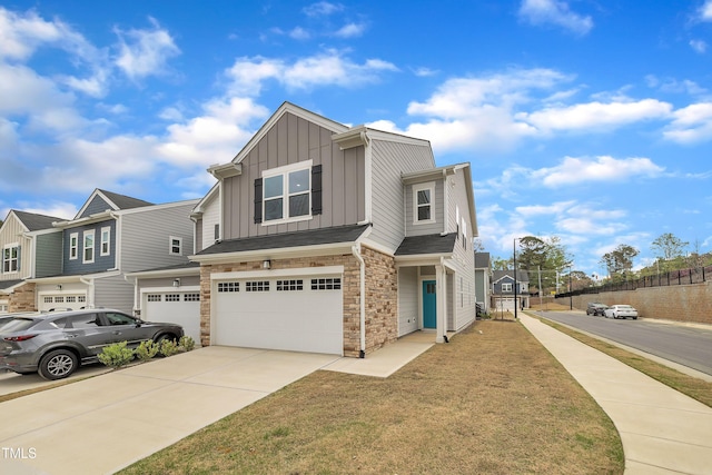 view of front facade featuring stone siding, a garage, board and batten siding, concrete driveway, and a residential view