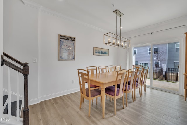 dining space with crown molding, baseboards, stairway, and light wood-style floors