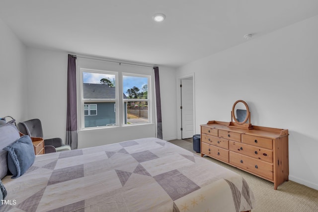 carpeted bedroom featuring baseboards