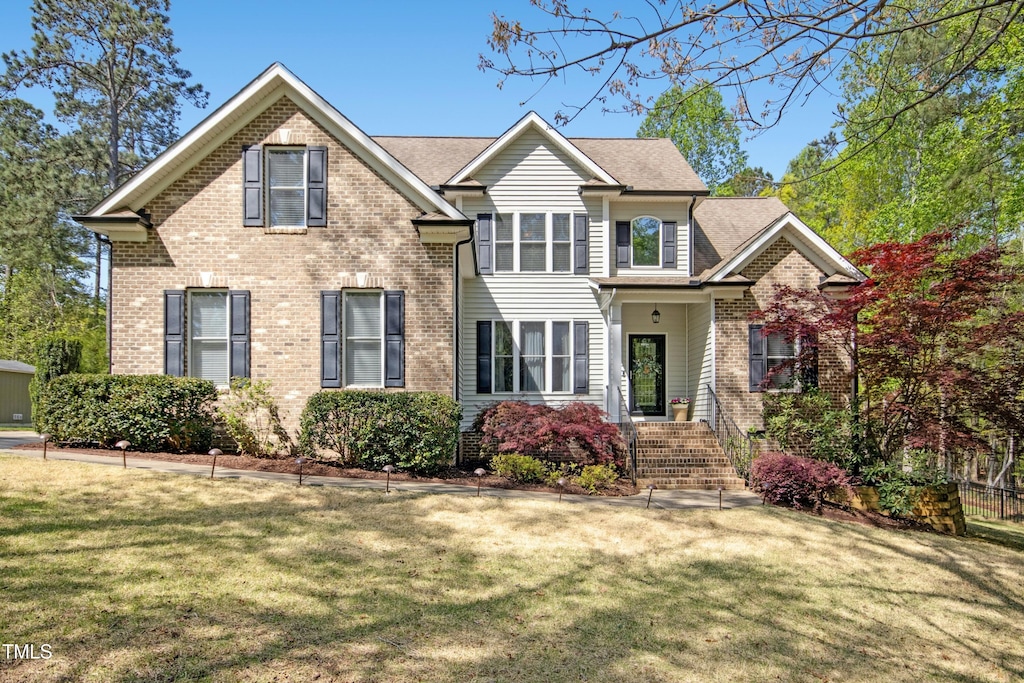1503 Anterra Dr, Wake Forest, NC 27587 - traditional home featuring a front yard and brick siding