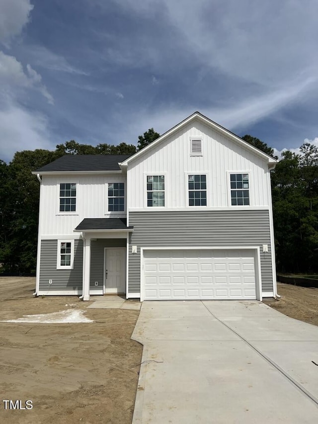 view of front of home with board and batten siding, an attached garage, and concrete driveway