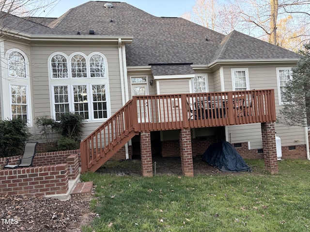 rear view of house featuring roof with shingles, a yard, stairs, and a wooden deck