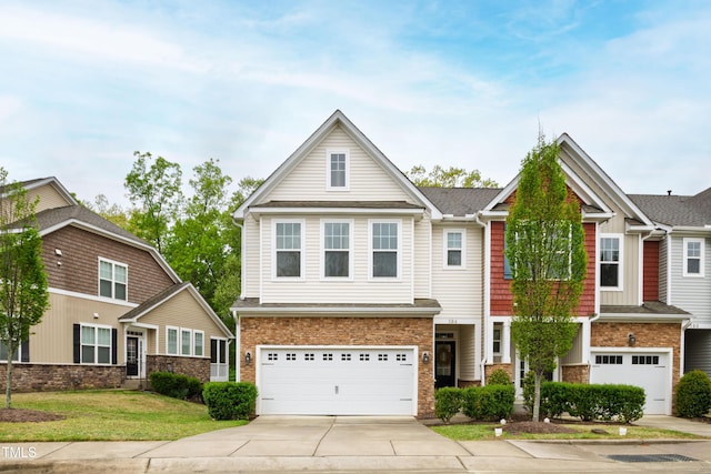 view of front facade with driveway, a garage, a front yard, and brick siding