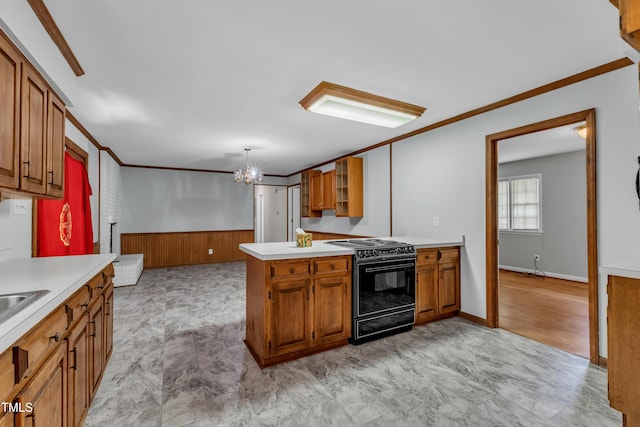 1500 Lakeside Dr, Garner, NC 27529 - kitchen with black range with electric cooktop, brown cabinetry, light countertops, ornamental molding, and glass insert cabinets