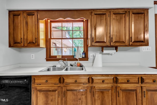 1500 Lakeside Dr, Garner, NC 27529 - kitchen with black dishwasher, light countertops, and brown cabinets