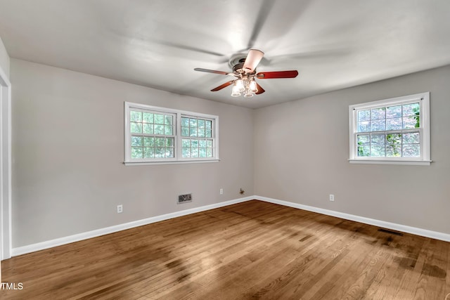 1500 Lakeside Dr, Garner, NC 27529 - empty room featuring plenty of natural light, ceiling fan, and wood finished floors