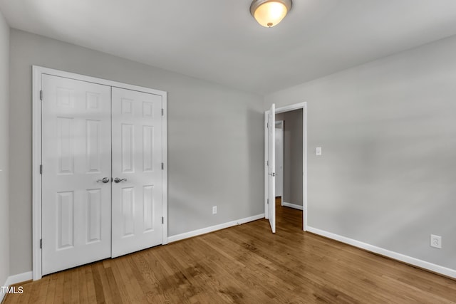 1500 Lakeside Dr, Garner, NC 27529 - unfurnished bedroom featuring wood finished floors and a closet