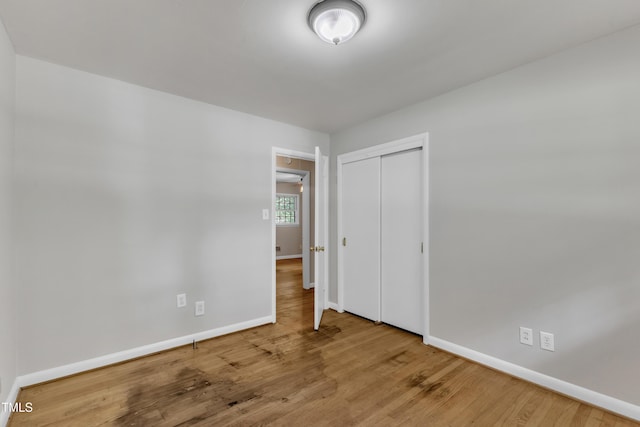 1500 Lakeside Dr, Garner, NC 27529 - unfurnished bedroom with wood finished floors and a closet