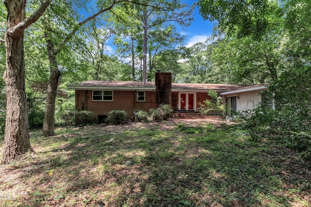 1500 Lakeside Dr, Garner, NC 27529 - view of front of property featuring a chimney, brick siding, french doors, and entry steps