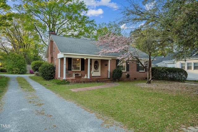 418 S 2nd St, Smithfield, NC 27577 - bungalow with roof with shingles, brick siding, a porch, a front yard, and a chimney