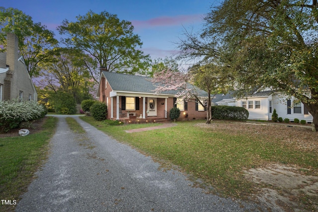 418 S 2nd St, Smithfield, NC 27577 - bungalow featuring covered porch, brick siding, driveway, and a lawn