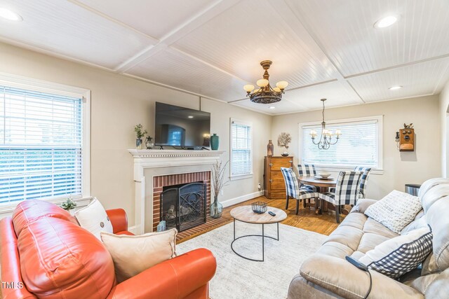 418 S 2nd St, Smithfield, NC 27577 - living room featuring baseboards, an inviting chandelier, a healthy amount of sunlight, and wood finished floors