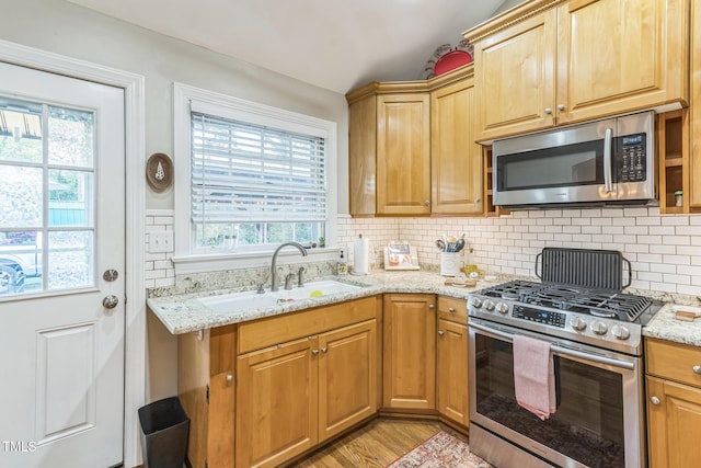 418 S 2nd St, Smithfield, NC 27577 - kitchen with a sink, appliances with stainless steel finishes, backsplash, and a healthy amount of sunlight