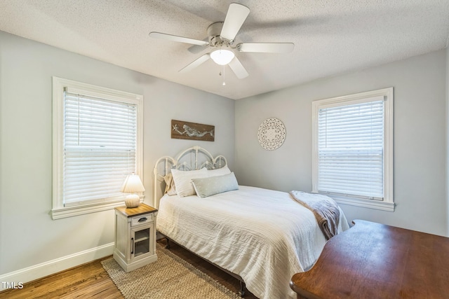 418 S 2nd St, Smithfield, NC 27577 - bedroom with light wood-type flooring, a textured ceiling, baseboards, and ceiling fan