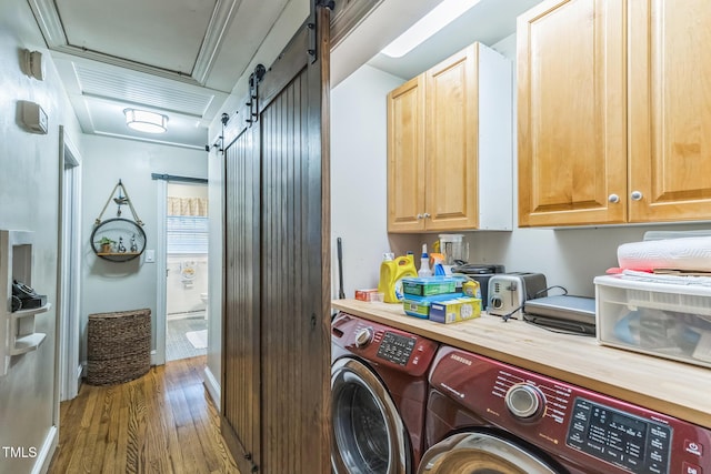 418 S 2nd St, Smithfield, NC 27577 - washroom with a barn door, cabinet space, wood finished floors, and washer and dryer
