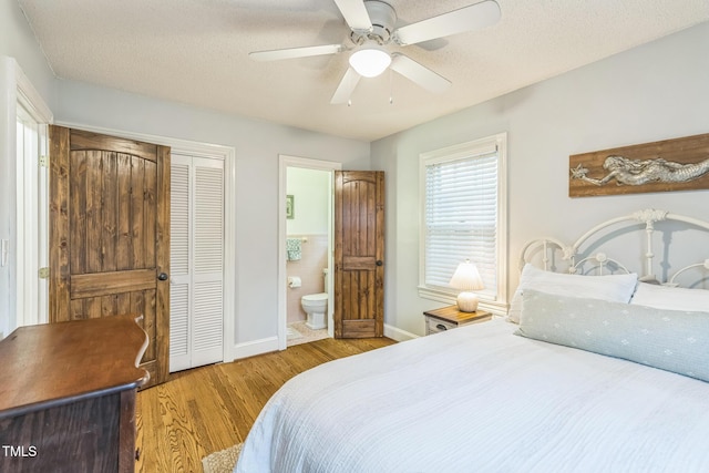 418 S 2nd St, Smithfield, NC 27577 - bedroom featuring connected bathroom, ceiling fan, baseboards, wood finished floors, and a closet