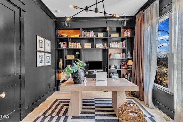 office area with visible vents and built in shelves