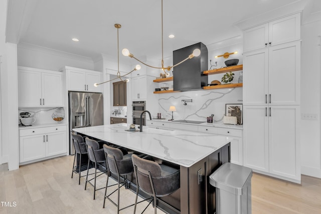 kitchen with white cabinets, exhaust hood, appliances with stainless steel finishes, and open shelves