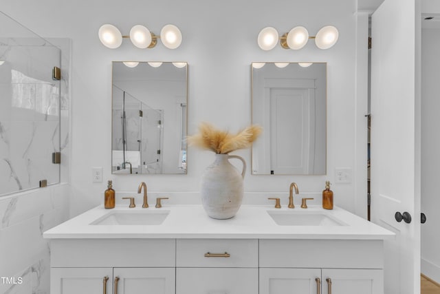 bathroom featuring double vanity, a sink, and a marble finish shower