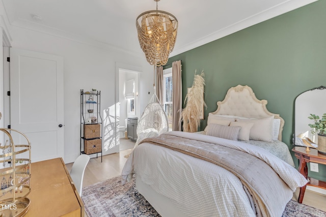 bedroom with ensuite bathroom, crown molding, light wood-style floors, and a chandelier