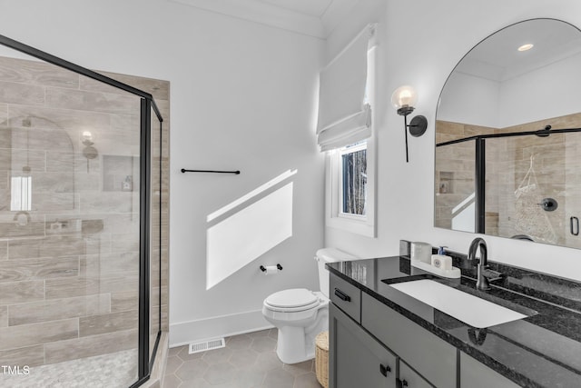 full bath with toilet, vanity, a shower stall, and visible vents