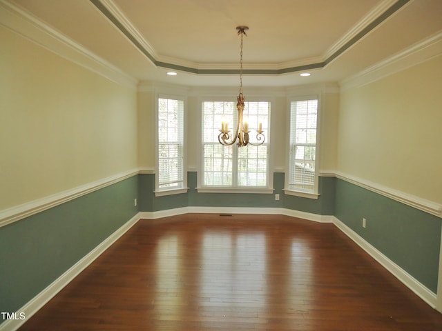 109 Bright Shade Ct, Holly Springs, NC 27540 - unfurnished dining area featuring an inviting chandelier, a tray ceiling, crown molding, and wood finished floors