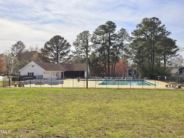 pool featuring fence and a lawn