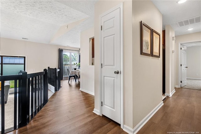 6611 Brannan Way, Fayetteville, NC 28314 - corridor with dark wood finished floors, baseboards, and a textured ceiling