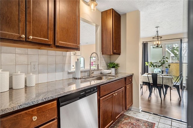 6611 Brannan Way, Fayetteville, NC 28314 - kitchen with stainless steel dishwasher, a sink, tasteful backsplash, stone countertops, and a textured ceiling