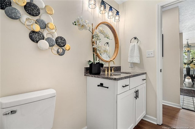 6611 Brannan Way, Fayetteville, NC 28314 - bathroom featuring toilet, wood finished floors, vanity, and baseboards