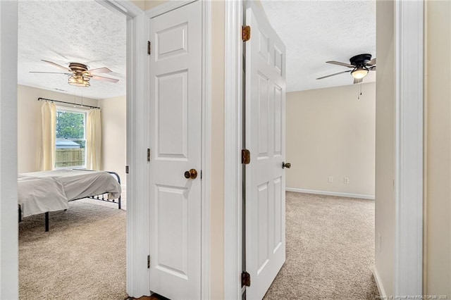 6611 Brannan Way, Fayetteville, NC 28314 - hallway featuring a textured ceiling, carpet floors, and baseboards