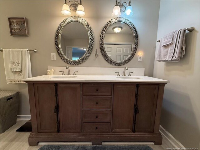 891 Long Iron Dr, Fayetteville, NC 28312 - bathroom with baseboards, double vanity, and a sink