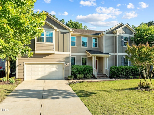 view of front of home with board and batten siding, concrete driveway, a garage, and a front yard