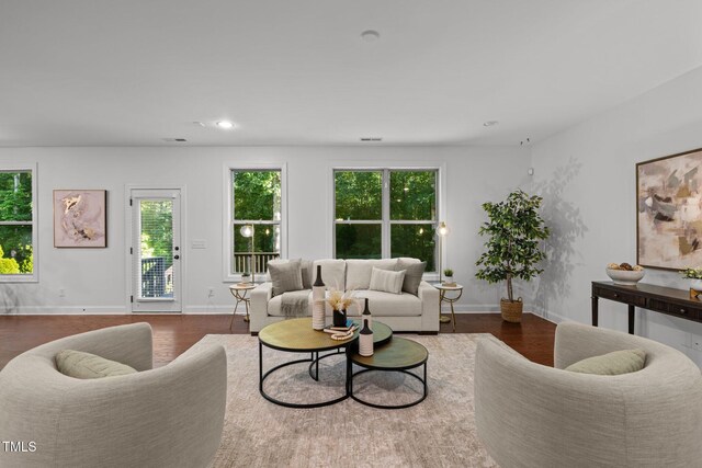 living area featuring recessed lighting, baseboards, and wood finished floors