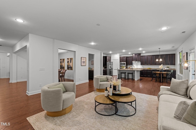 living area featuring dark wood-type flooring, recessed lighting, and baseboards