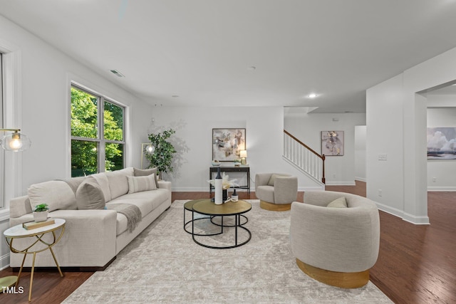 living area with stairway, wood finished floors, baseboards, and recessed lighting