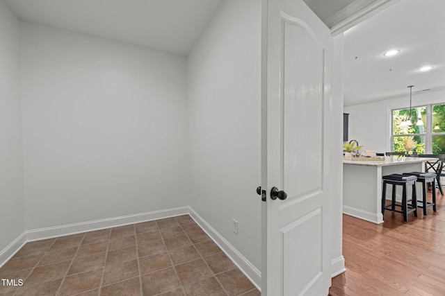 hall with recessed lighting and baseboards