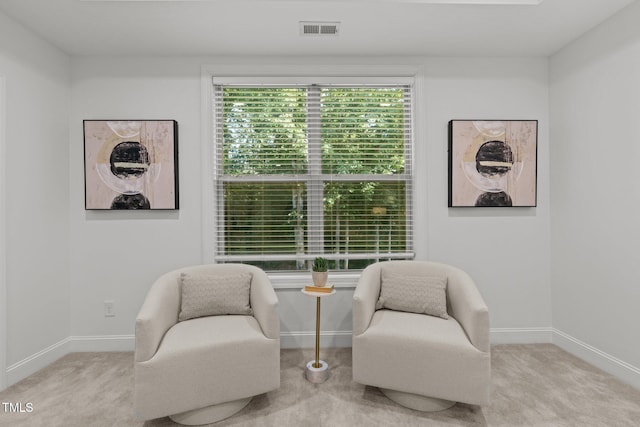 living area with carpet floors and baseboards