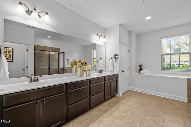 full bathroom featuring a shower stall, double vanity, tile patterned floors, recessed lighting, and baseboards