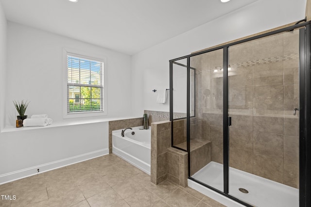 bathroom featuring a garden tub, a shower stall, and tile patterned flooring