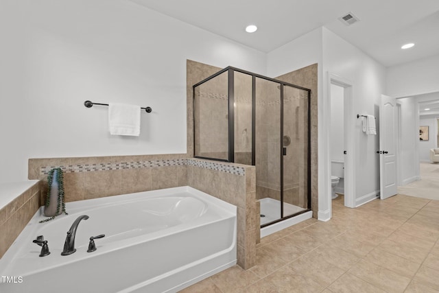 bathroom featuring a stall shower, a garden tub, toilet, tile patterned floors, and recessed lighting