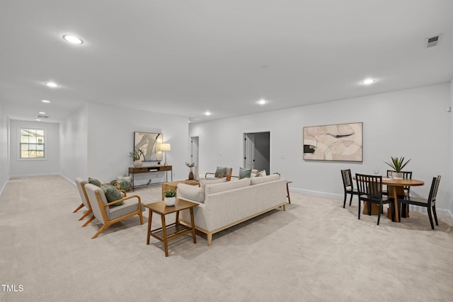 living room featuring recessed lighting, light carpet, and baseboards