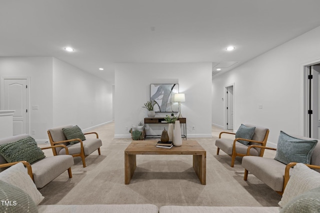 living room featuring recessed lighting, light colored carpet, and baseboards