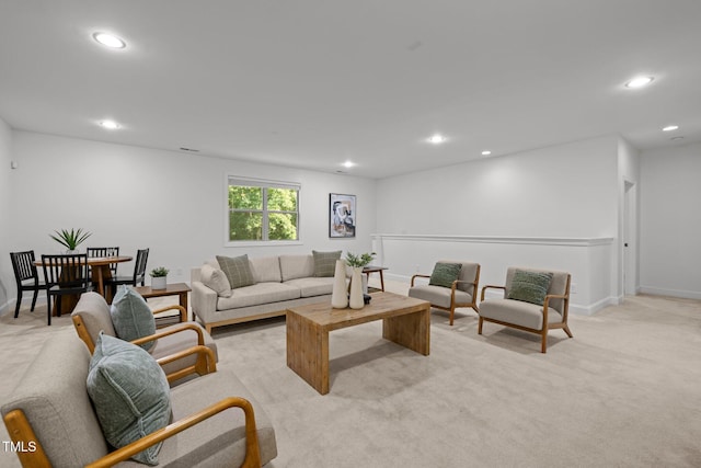 living room with recessed lighting, light colored carpet, and baseboards