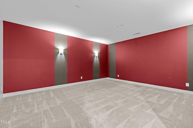 empty room featuring carpet and baseboards