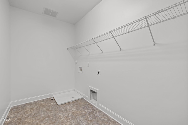 laundry area with electric dryer hookup, hookup for a washing machine, gas dryer hookup, and baseboards